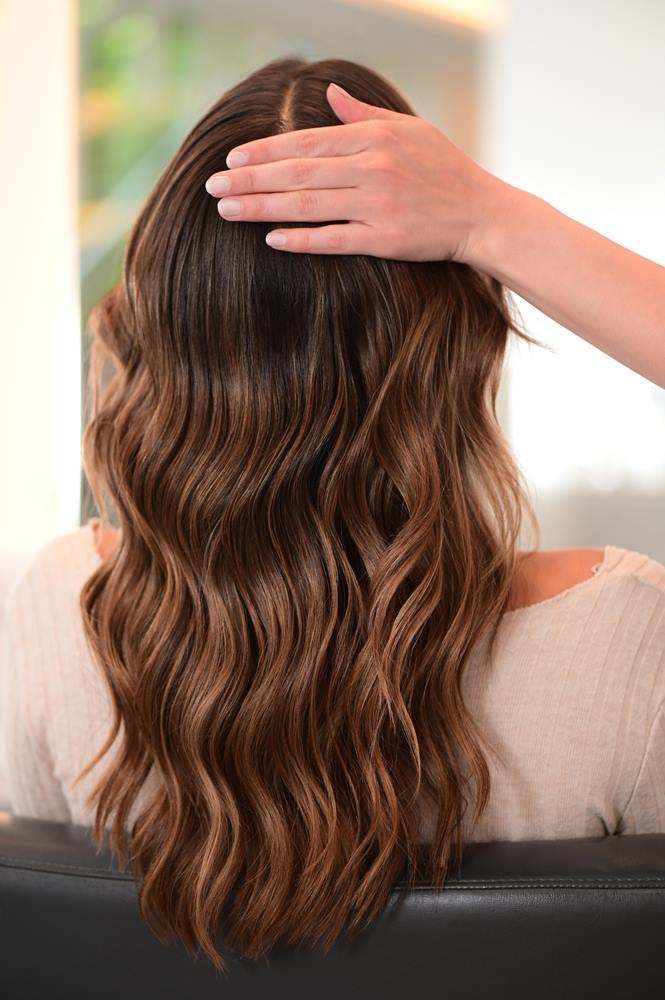 Woman with Long Wavy Brown Hair — Fraser Shores Hair Design In Urraween, QLD