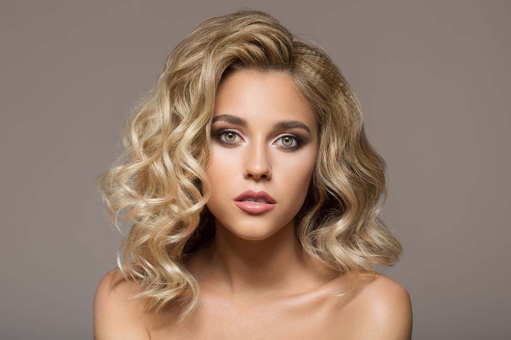 Portrait of A Blonde Woman with Curly Hair — Fraser Shores Hair Design In Urraween, QLD
