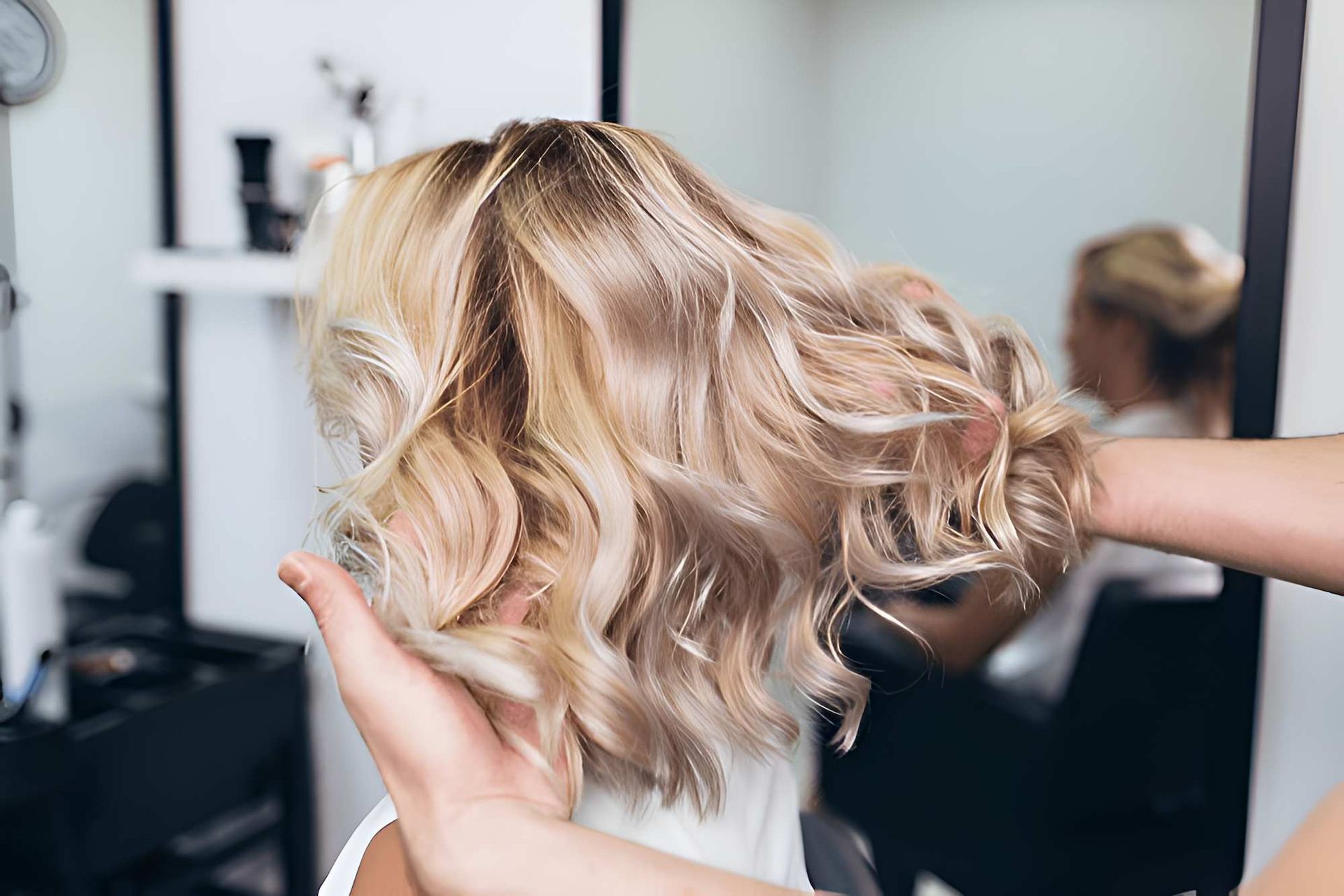 A Woman is Getting Her Hair Done at a Salon — Fraser Shores Hair Design in Fraser Coast, QLD