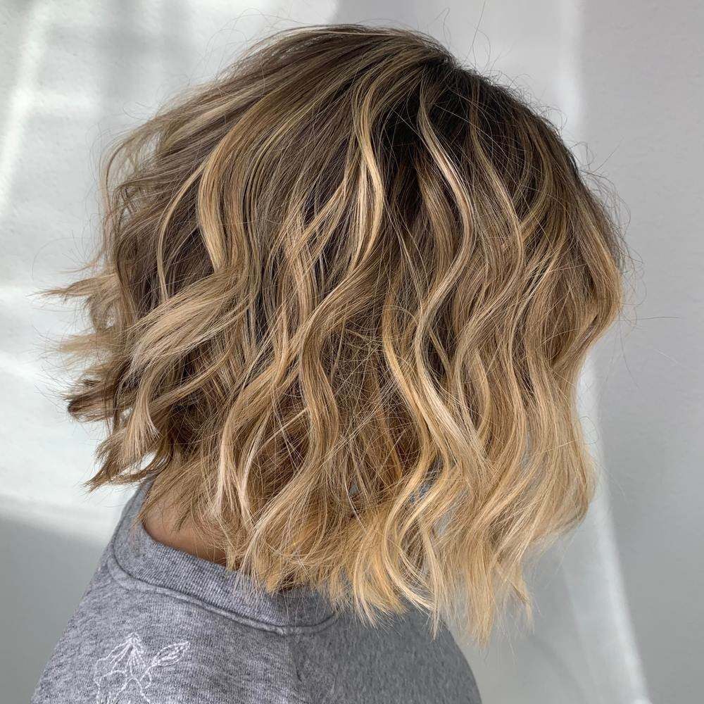 Short Wavy Layered Bob Haircut with Blonde Highlights and Darker Roots — Fraser Shores Hair Design in Urraween, QLD