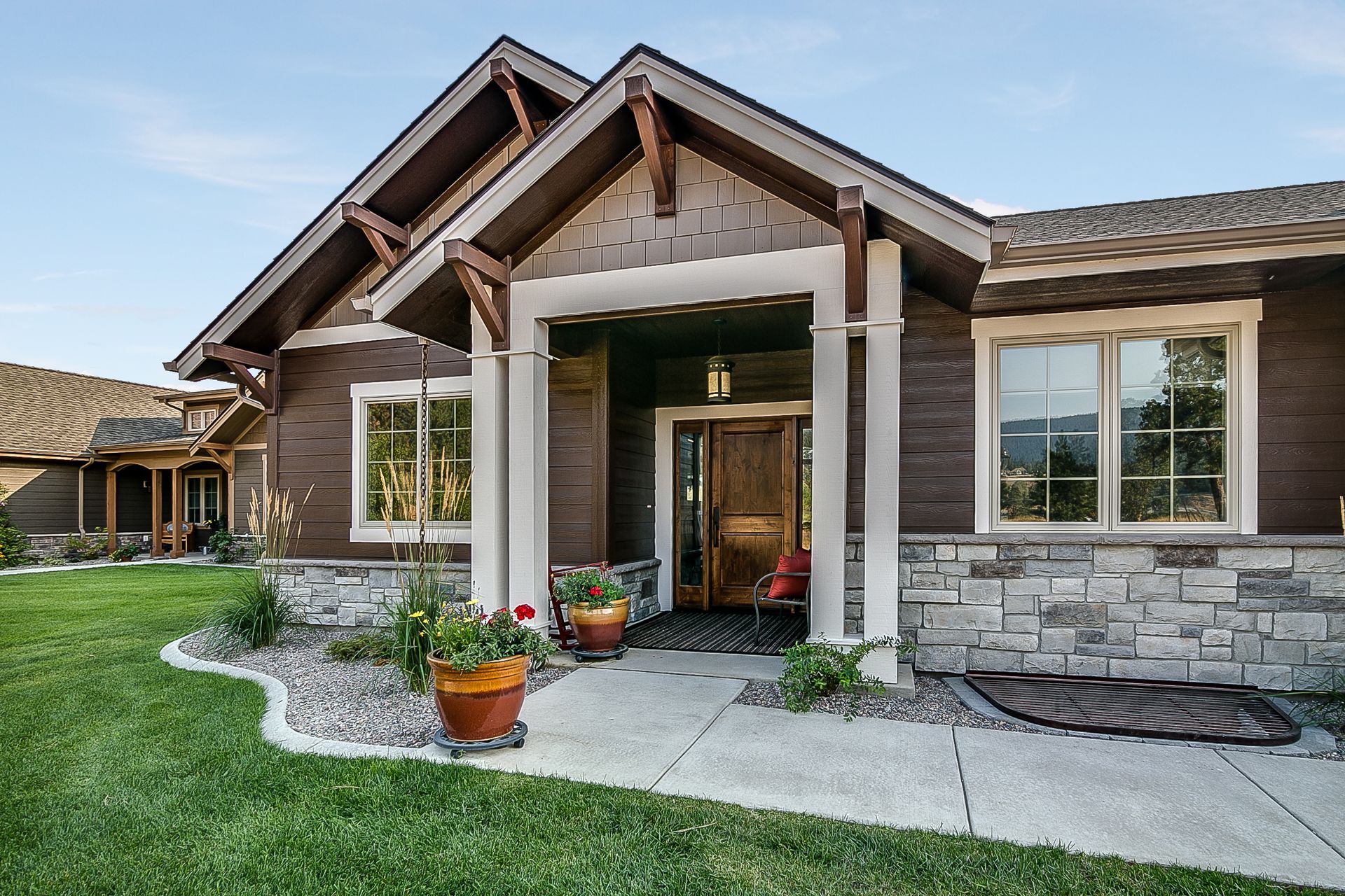 A large house with a large porch and a lot of windows