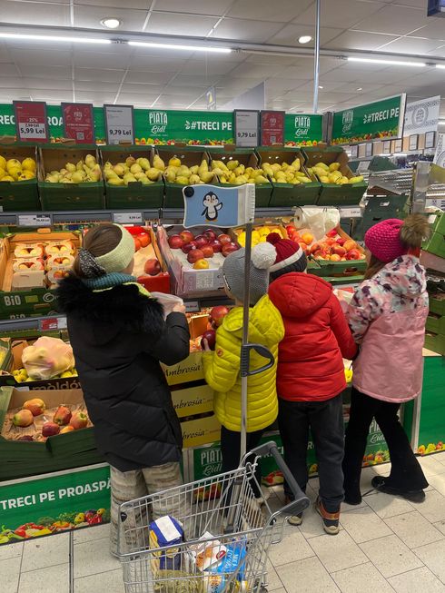 A group of people are shopping in a grocery store.