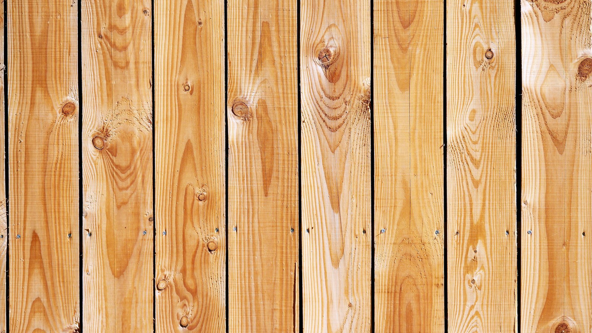 Close-up of natural and textured wood fencing supplies in Gainesville, GA Close-up of natural and textured wood fencing supplies in Gainesville, GA