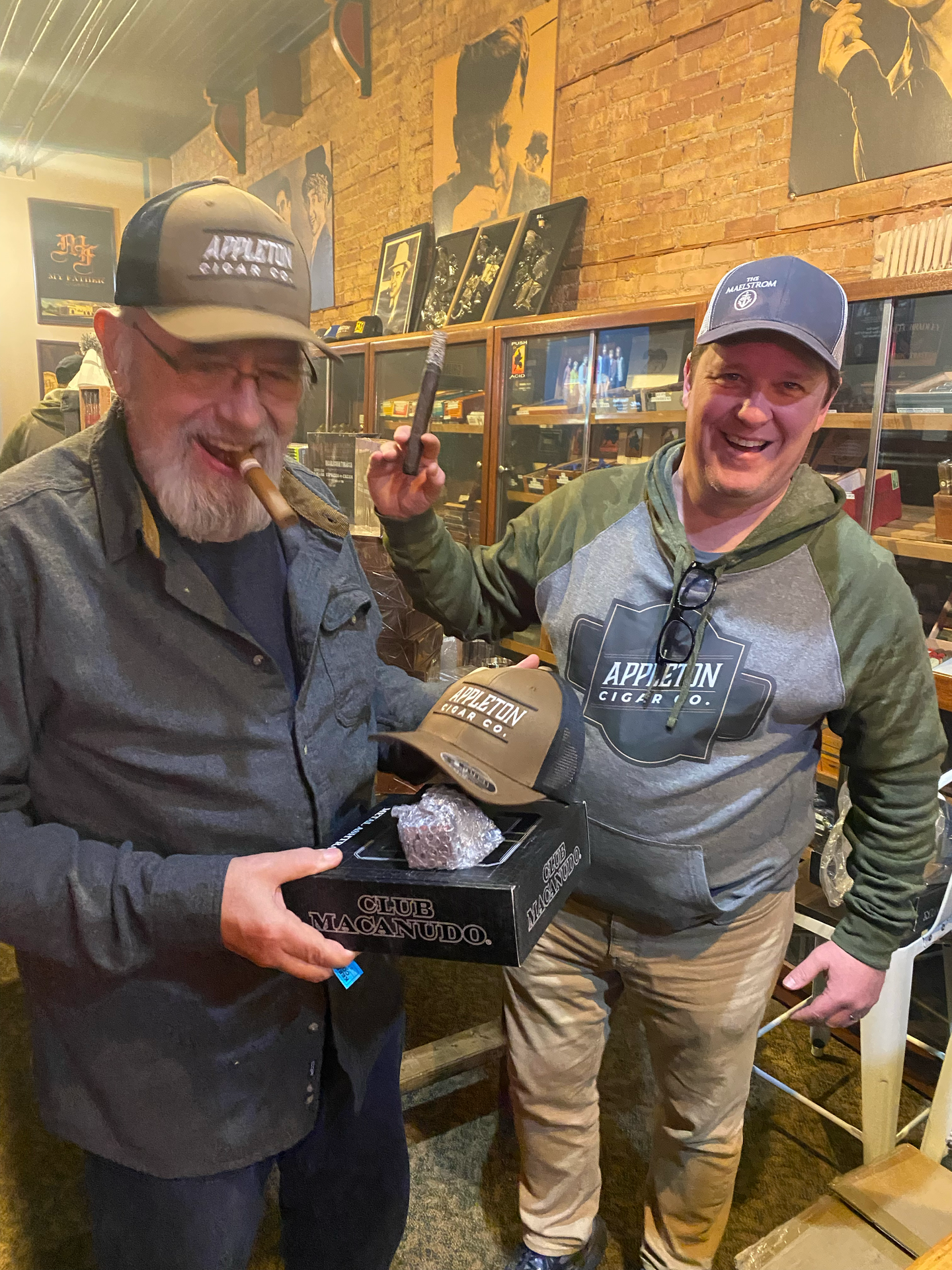 Karl and Wes Smiling with a handful of cigar accessories