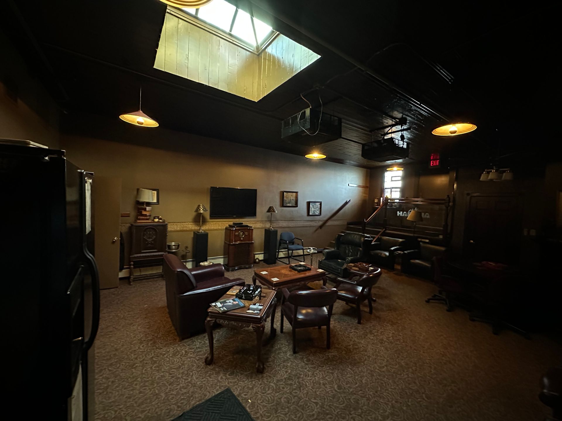 A cigar lounge with a table and chairs and a skylight