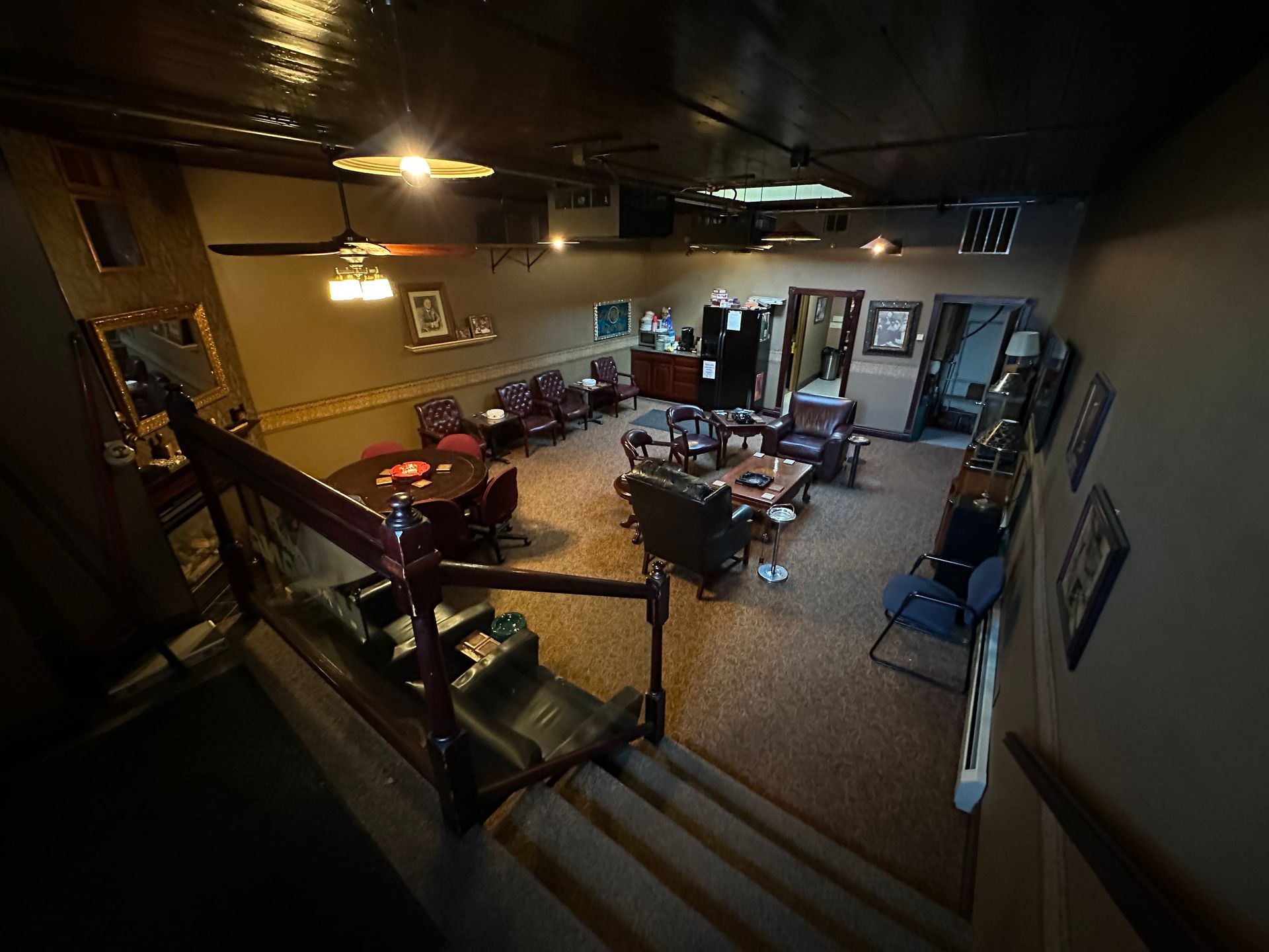 An aerial view of a living room with stairs leading up to it.