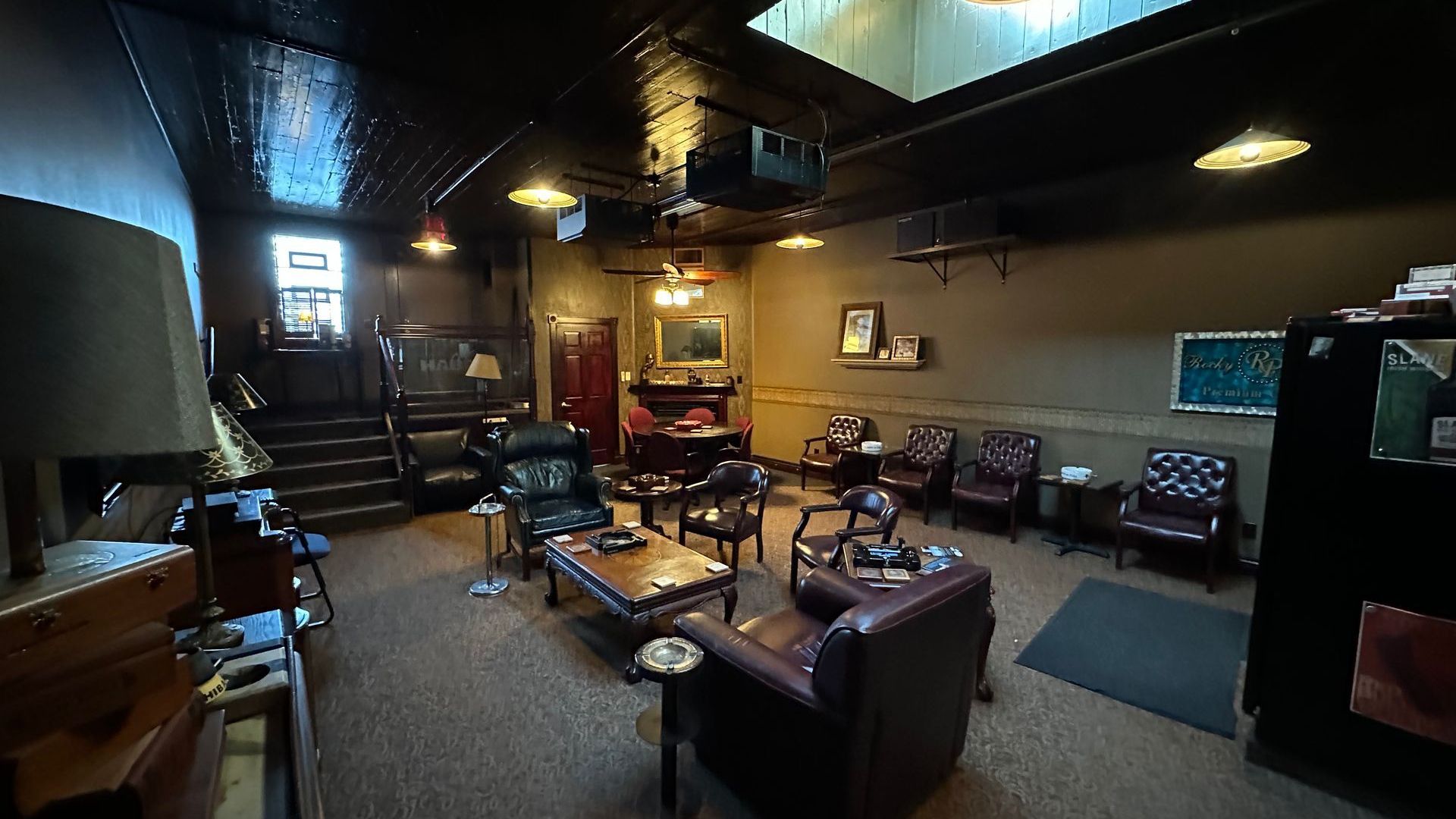 A living room with a lot of chairs and tables