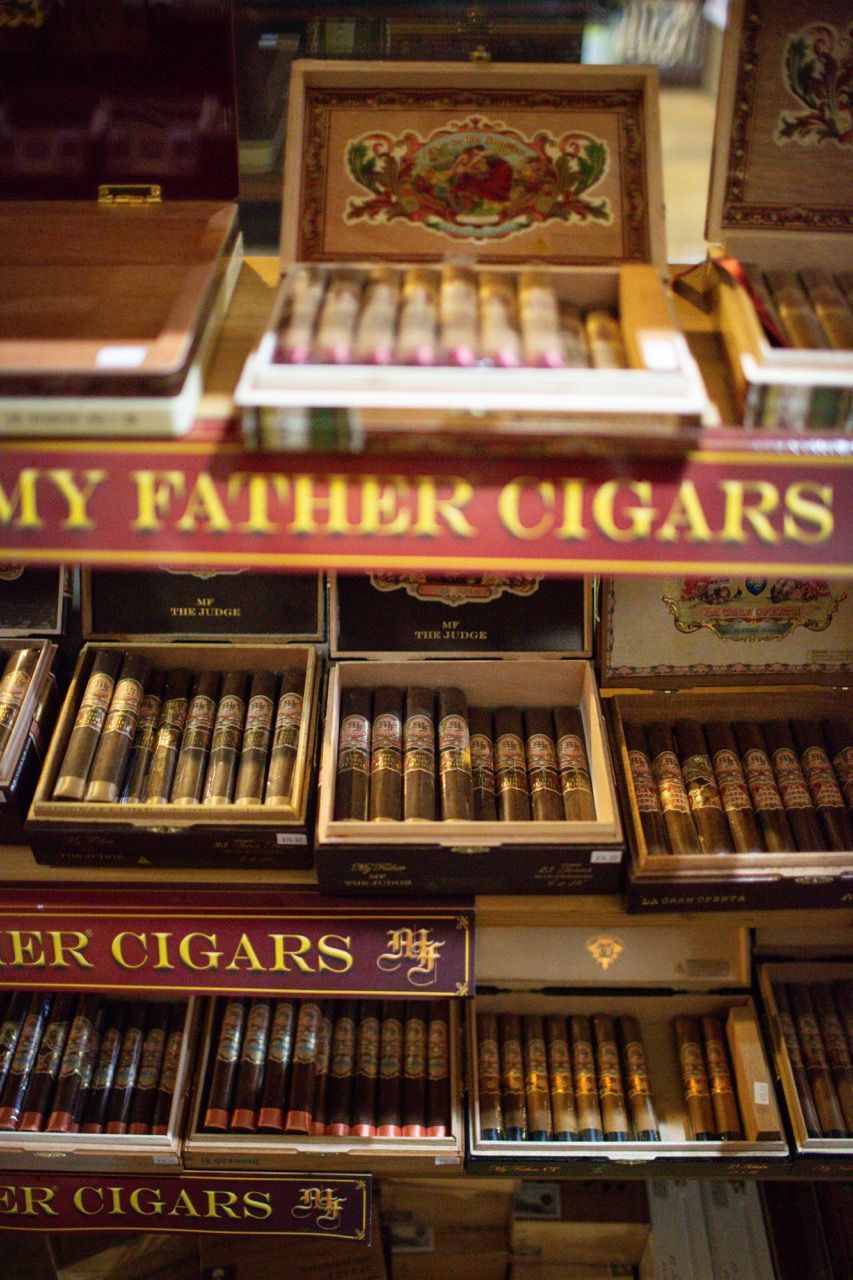 A display of cigars with a sign that says my father cigars