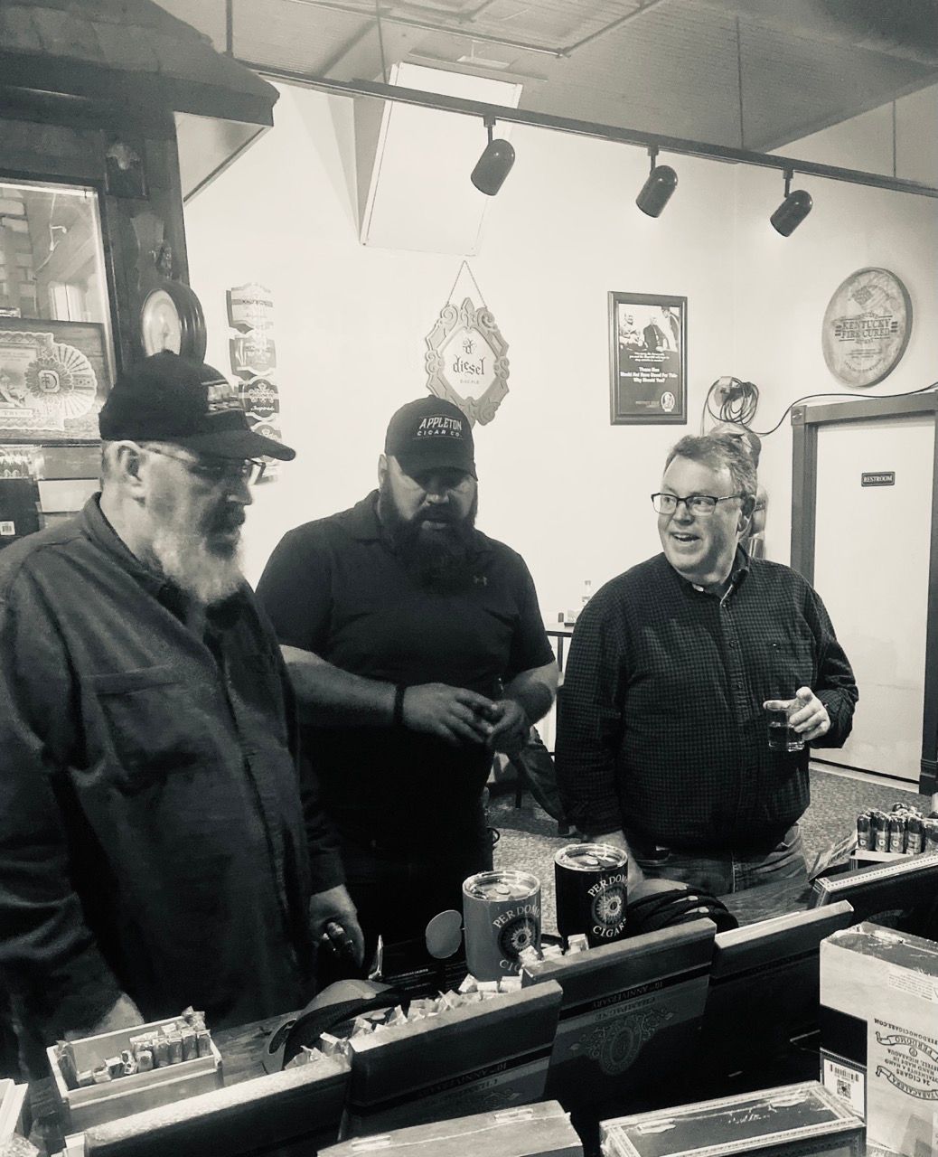 A black and white photo of three men in a bar