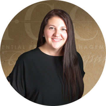 Woman with long brown hair, wearing a black shirt, set against a brown background with text.