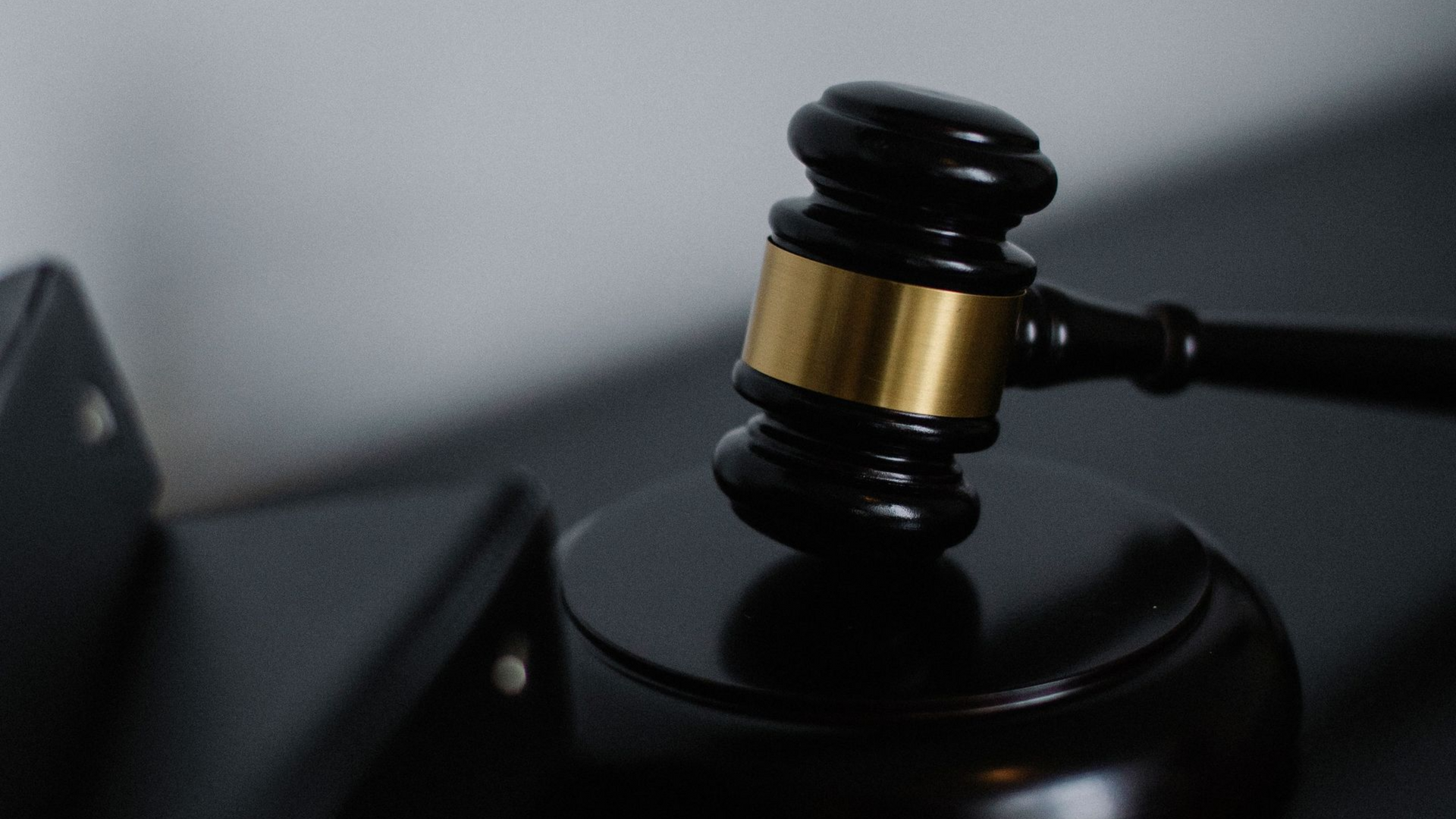 black and gold gavel on a desk