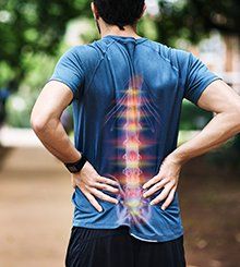 Man Holding His Back in Pain — Medford, OR — Lowengart Ruth Man Holding His Back in Pain — Medford, OR — Lowengart Ruth