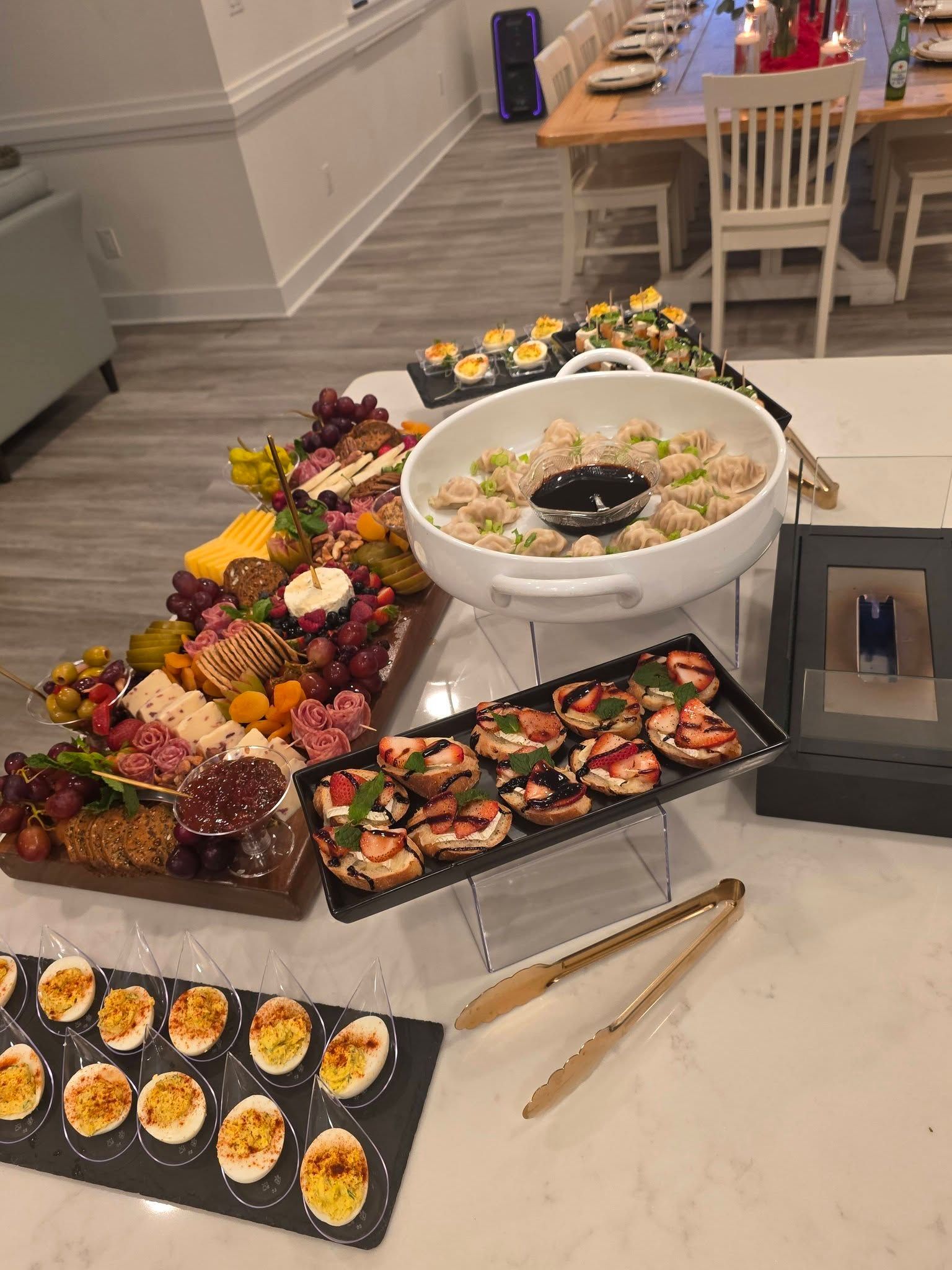 Buffet table with sushi, fruit, and appetizers arranged on trays in a bright dining room