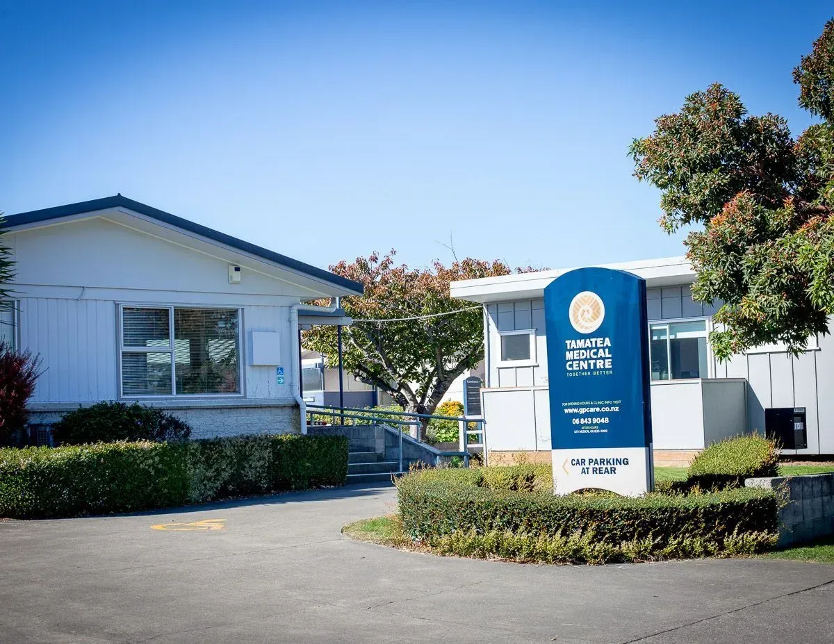 Exterior of Tamatea Medical Centre in Napier, with the medical centre sign beside the front path