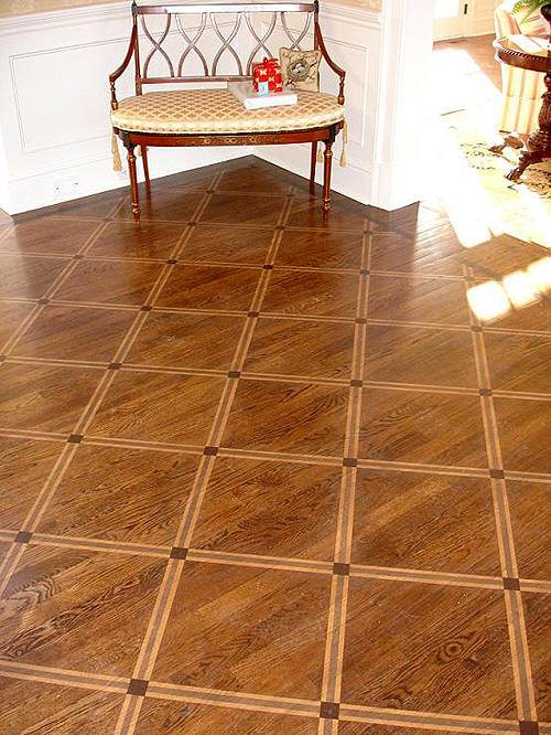 Wood parquet floor with a grid pattern, featuring a bench in the corner.