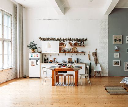 There is a table and chairs in the middle of the room.