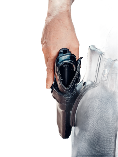 Hand holding a handheld vacuum cleaning a gray fabric surface