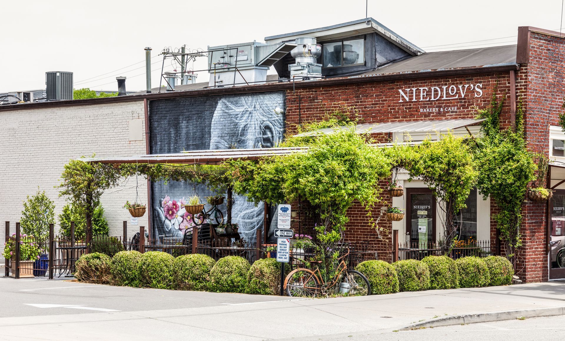 A brick building with a bicycle parked in front of it.