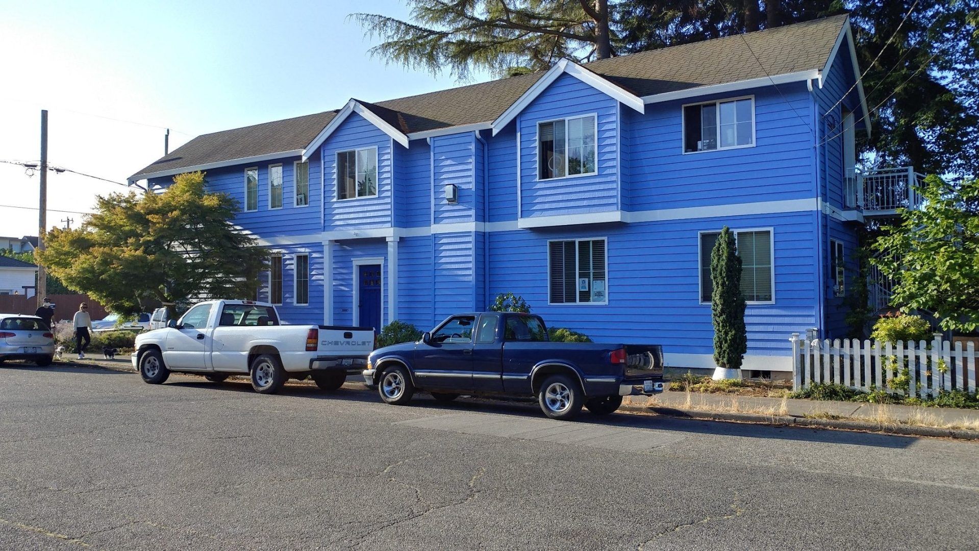 Two Pickup Truck On The Front Of House — Seattle, WA — Cordeck Painting Services LLC