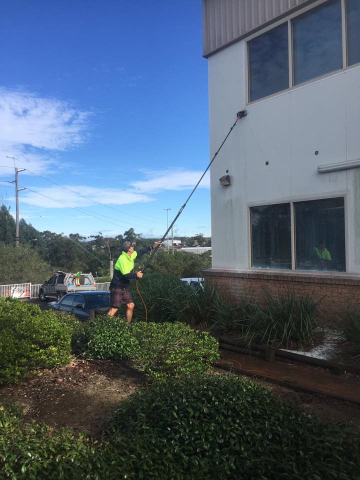 Worker Cleaning Exterior Of A Building — ACME Cleaning In Kariong, NSW