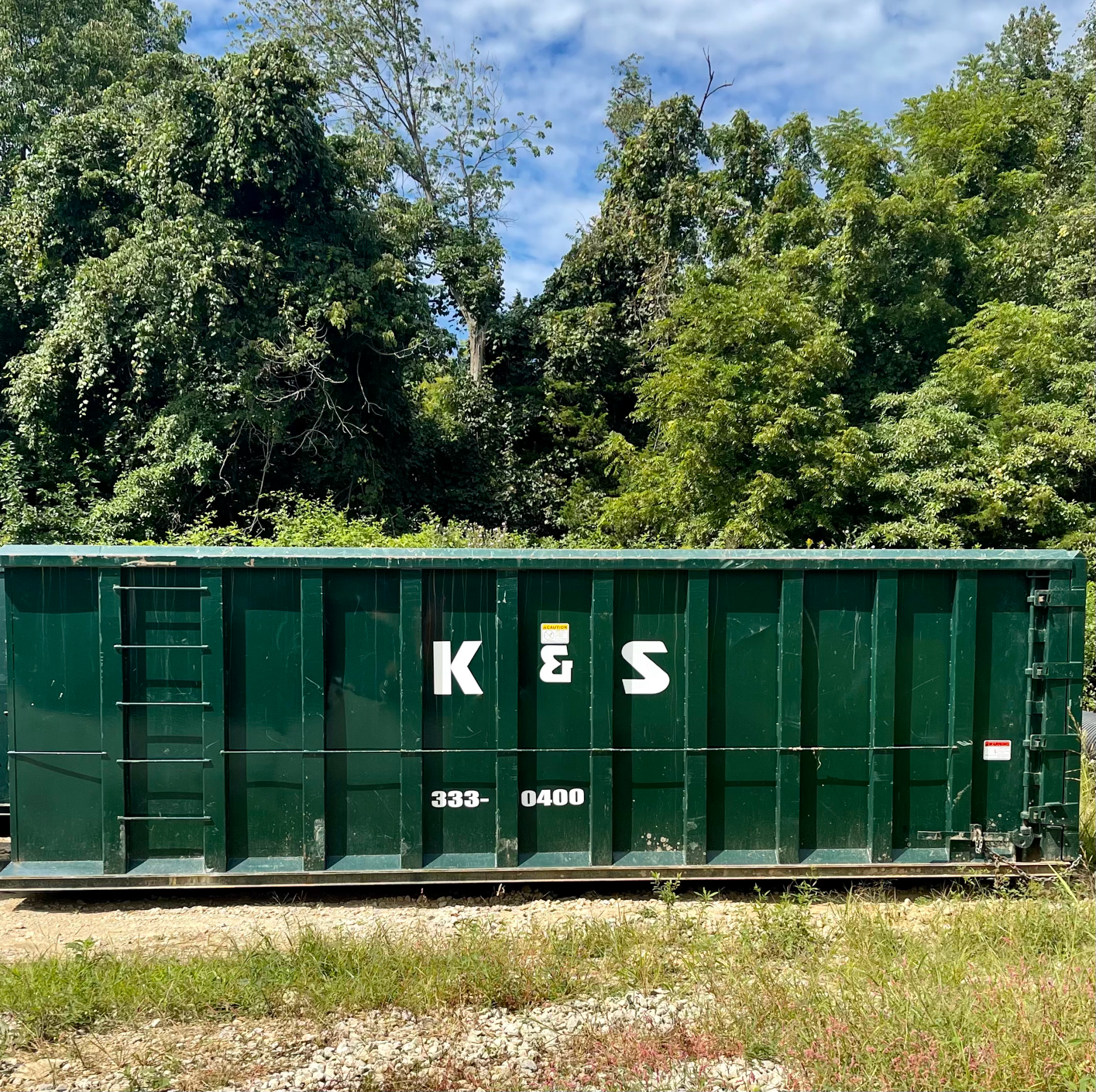 A green container with the word kes on it