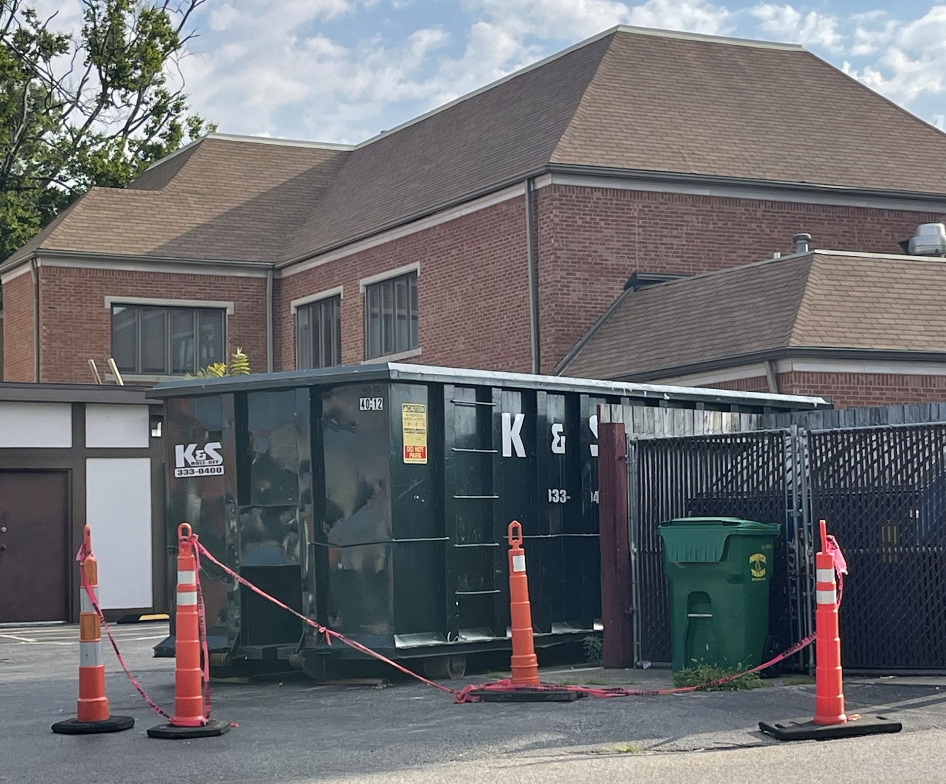 A dumpster with the letter k on it
