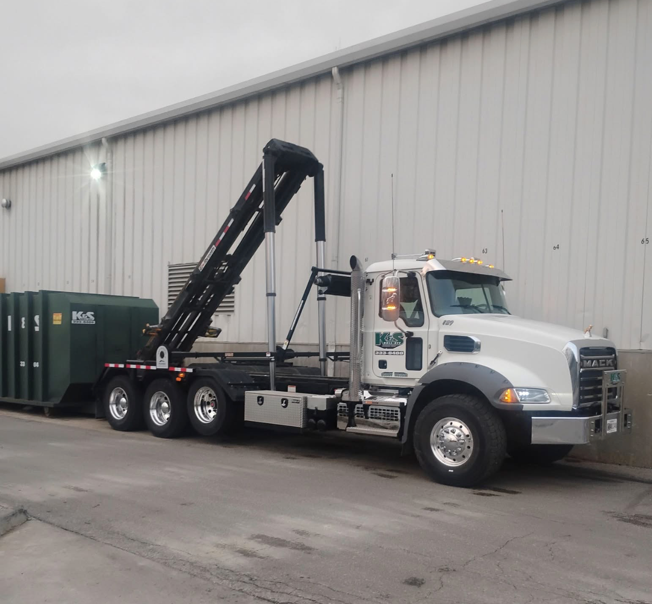 Empty industrial dumpster on the street.