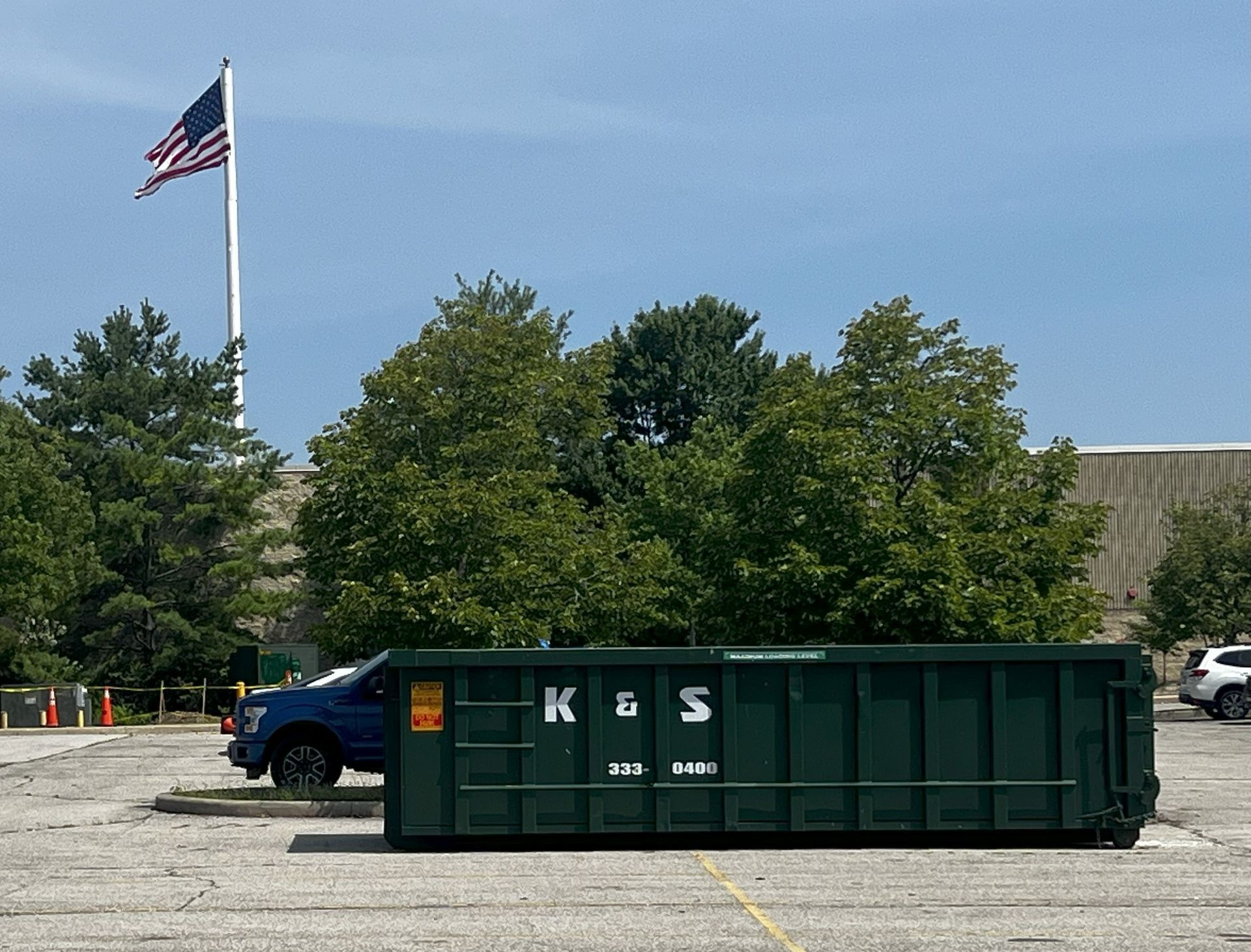 Roll-off dumpster from K & S Rolloff in Trafalgar, IN, being filled with construction debris