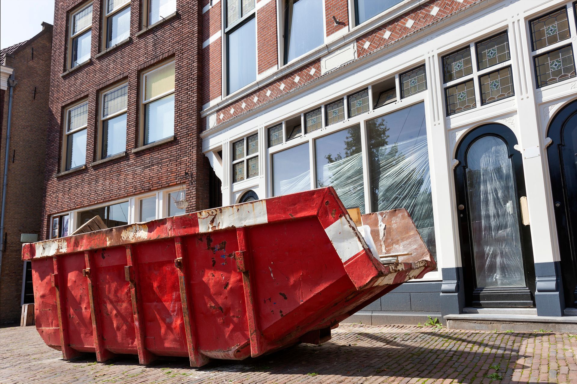 A dumpster in front of a building.