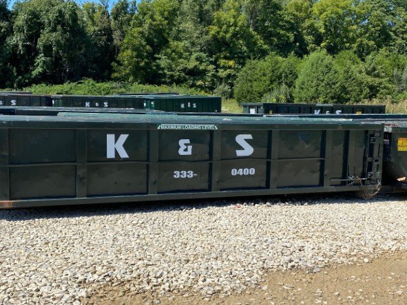 A dumpster with the letters k and s on it