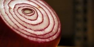 A close up of a sliced red onion on a table.