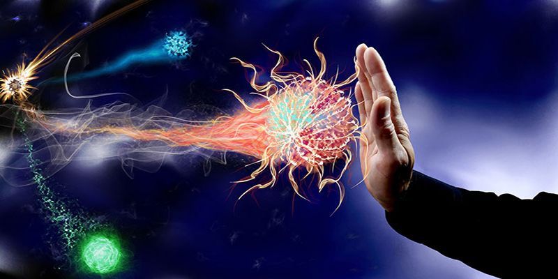 A person is holding their hand up to stop a virus.