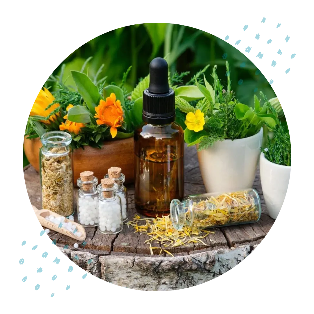 A wooden table topped with homeopathy bottles of herbs and flowers.