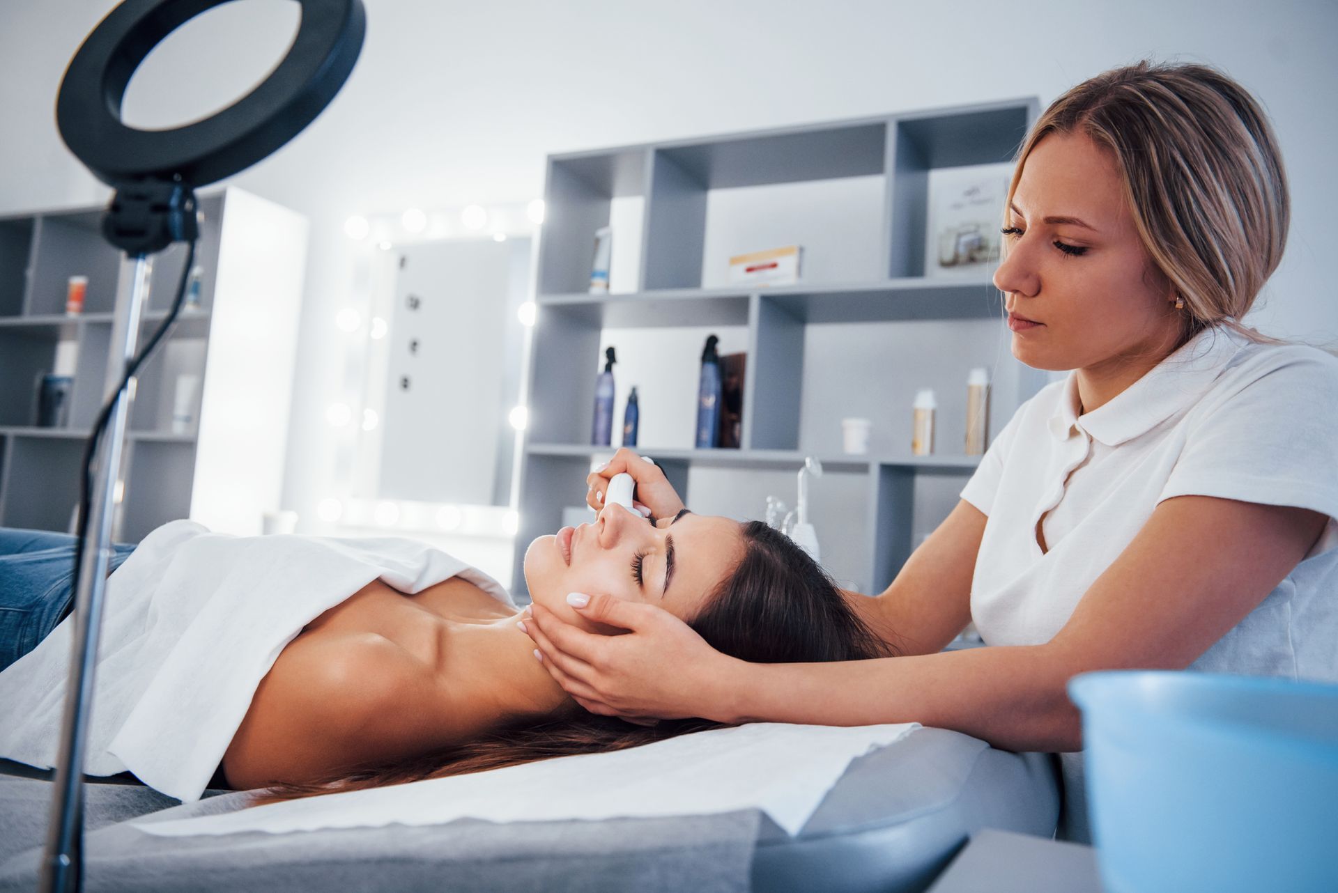 A woman is getting a face cleaning procedure.