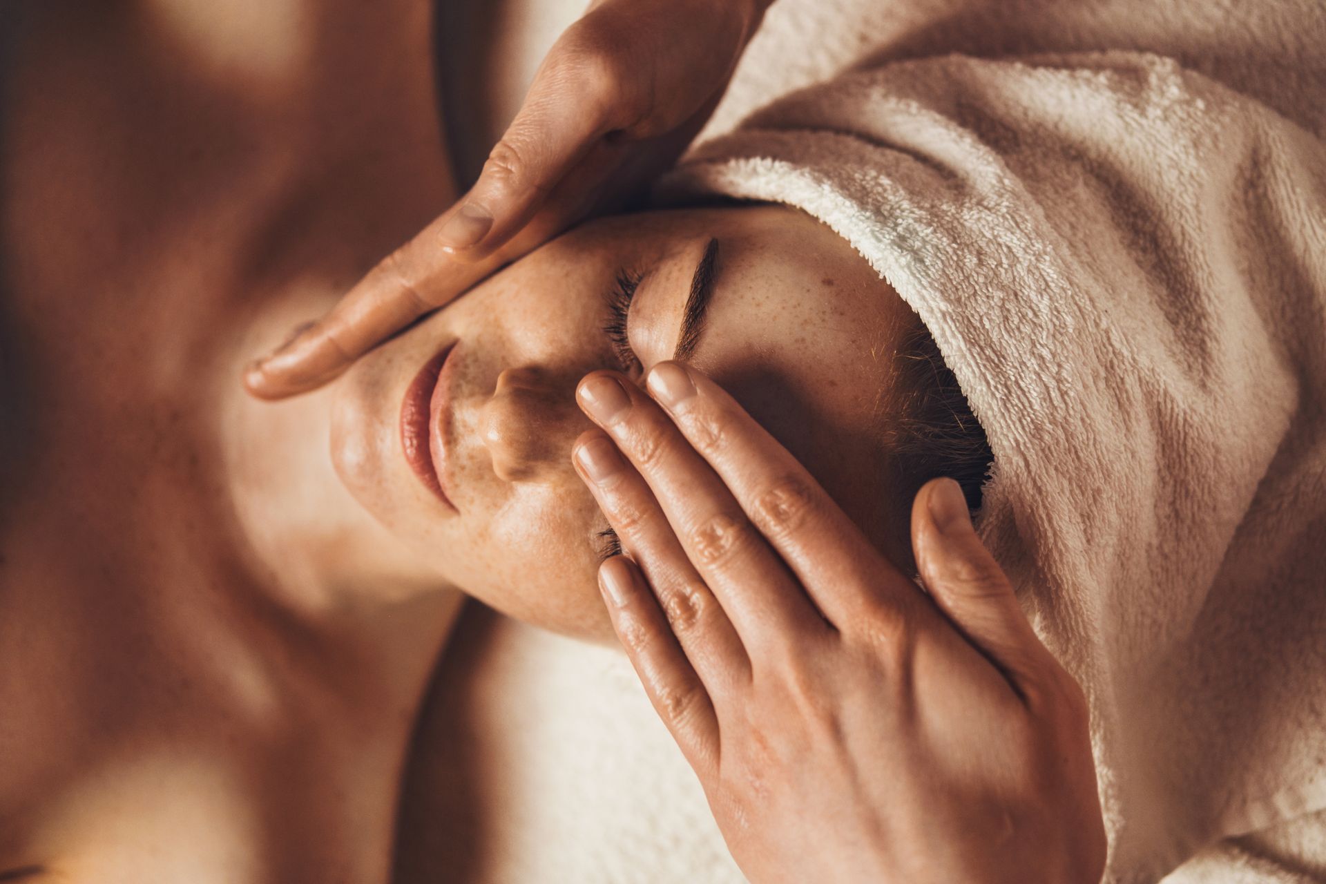Top view of smiling freckled woman relaxing during myofascial massaging therapy. Top view of smiling freckled woman relaxing during myofascial massaging therapy.