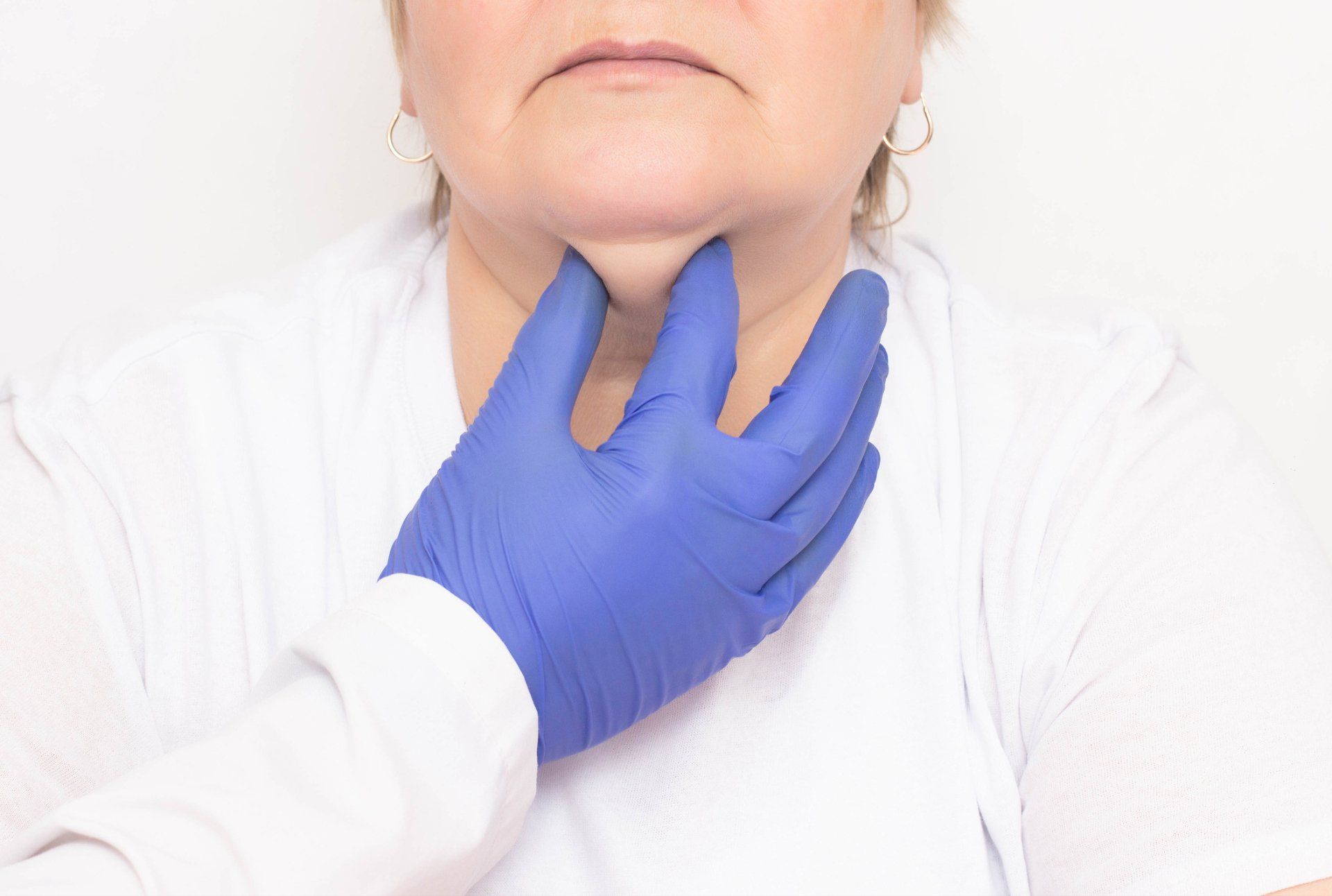Double chin exam/treatment Person's neck being examined by a gloved hand.