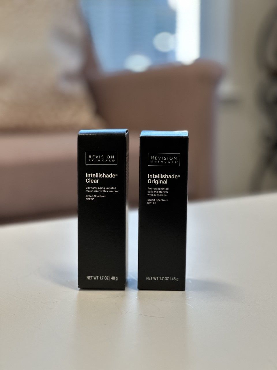 Two black product boxes on a white surface, one labeled 