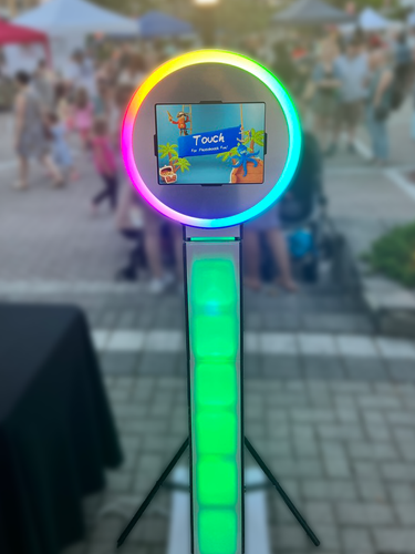 A photo booth with a rainbow colored ring around it