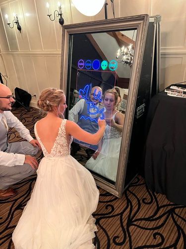 A bride and groom signing Mirror ME