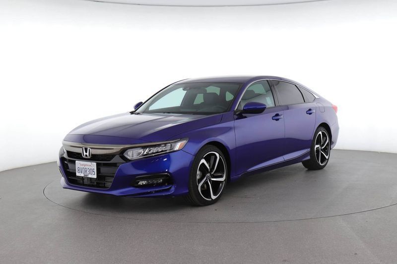 Blue Honda sedan in a studio setting, angled front view on a white background