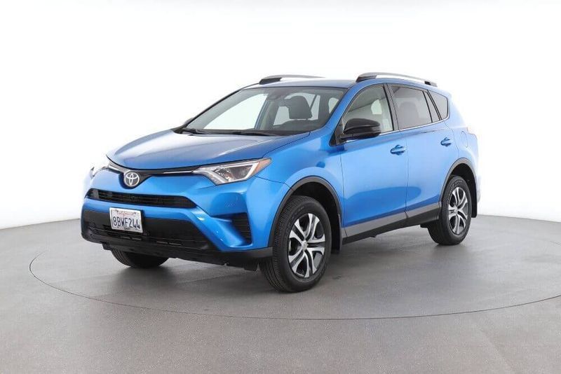 Blue Toyota RAV4 SUV on a studio white background, front three-quarter view.