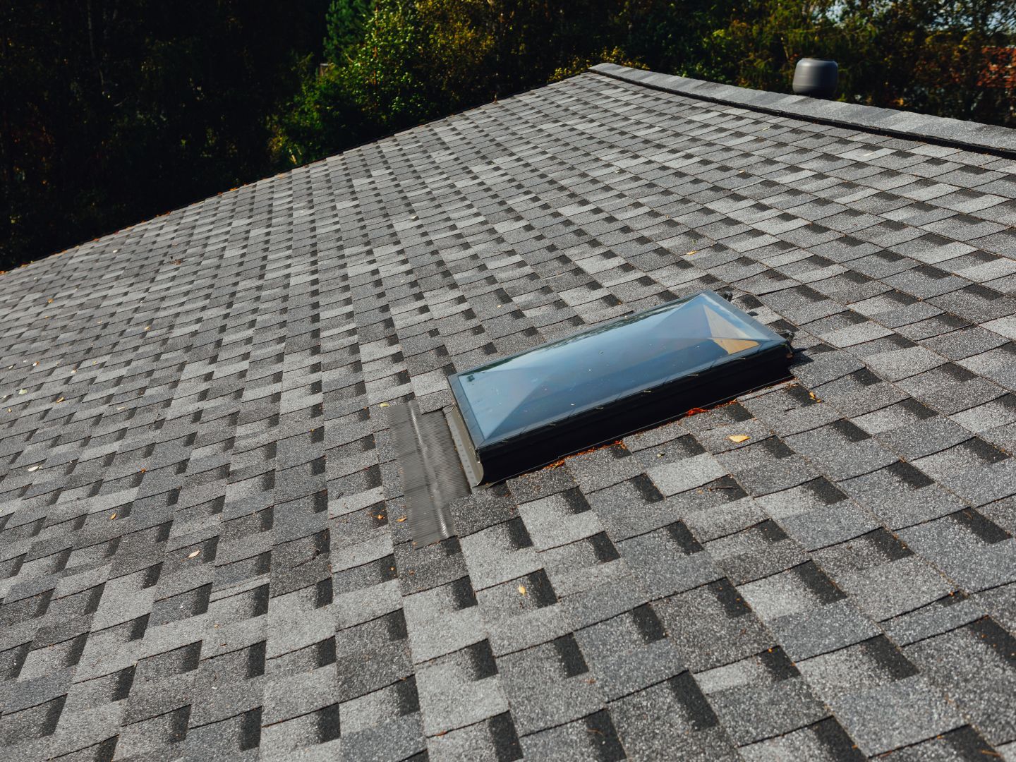There is a skylight on the roof of a house.