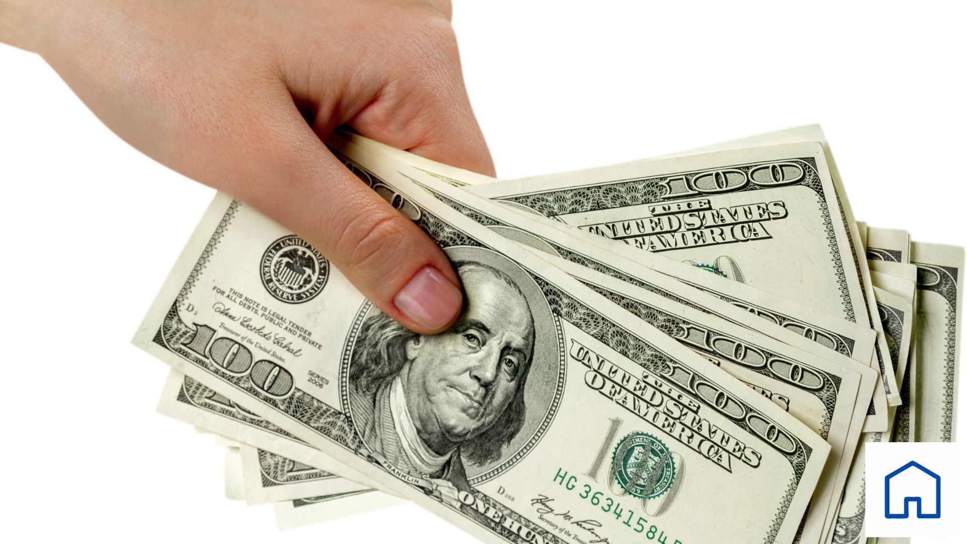 A hand is holding a stack of 100 dollar bills
