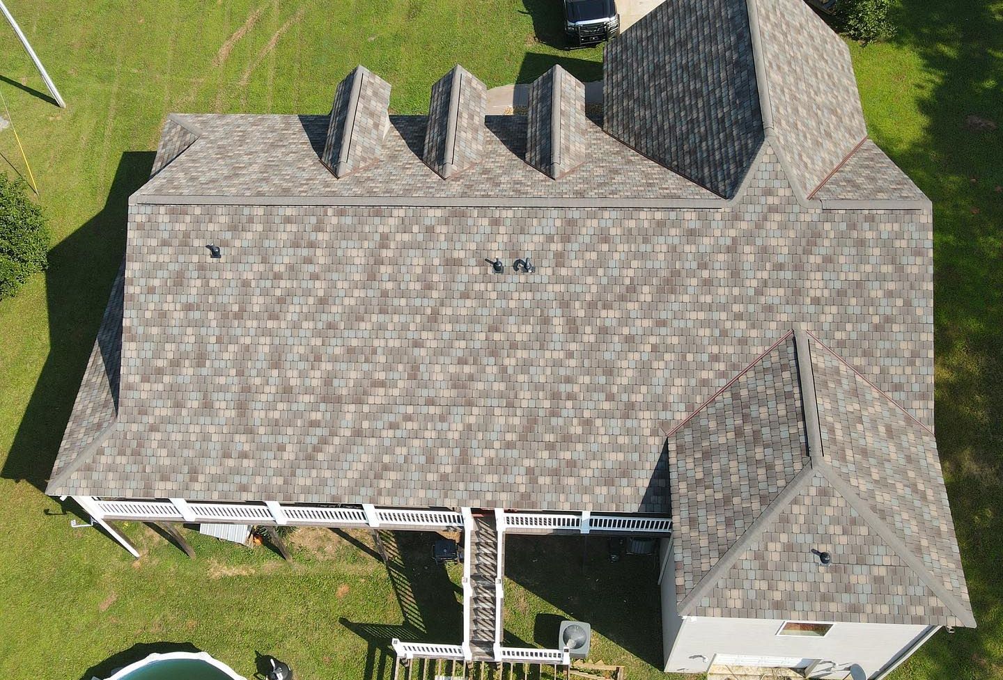 An aerial view of a house with a roof and a pool in Temple Ga