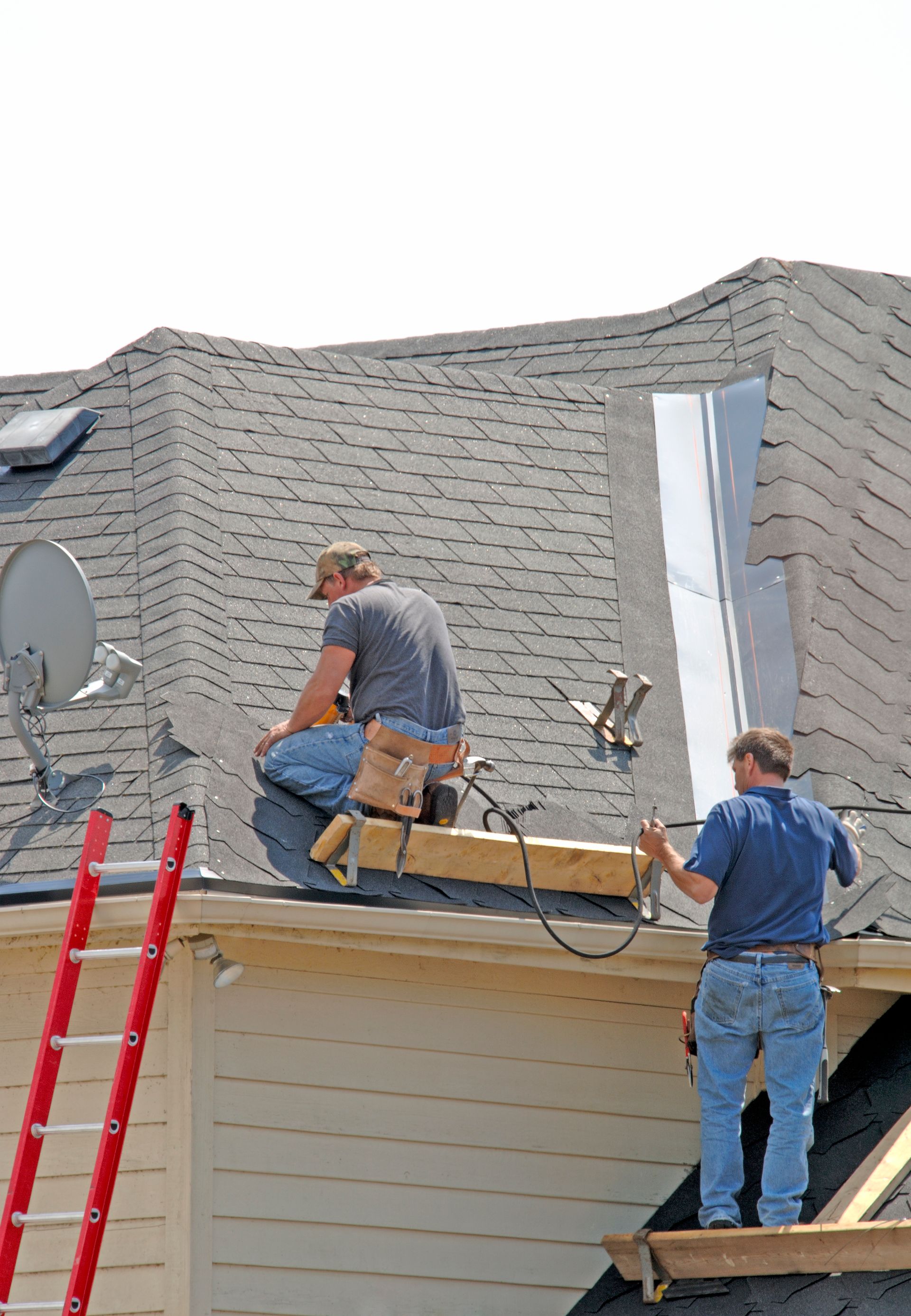 Two men are working on the roof of a house in Heard County Ga.
