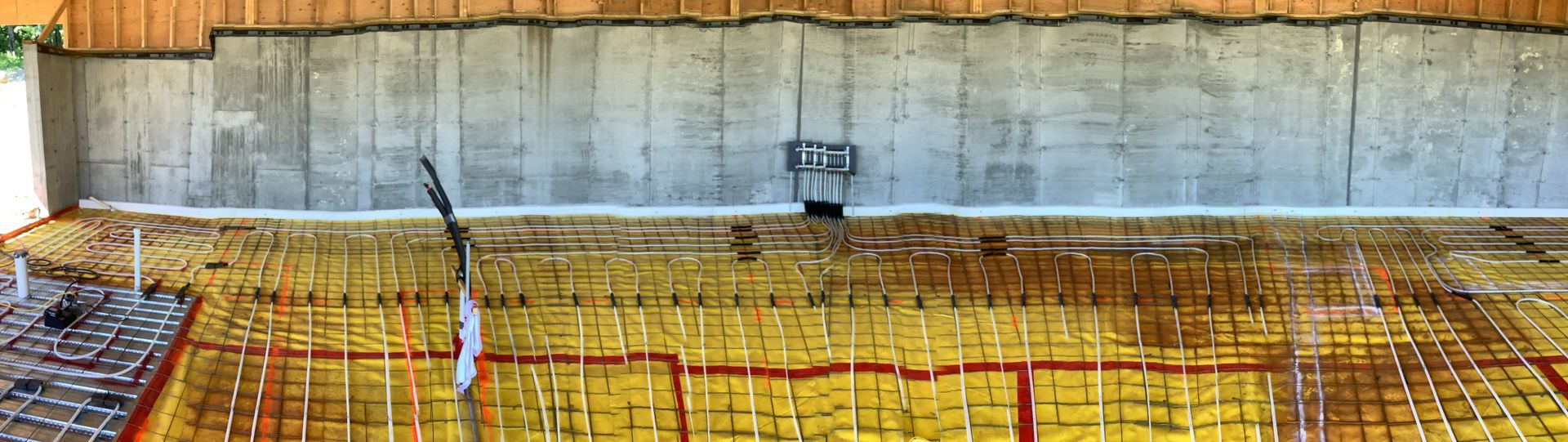 Construction site with concrete retaining wall and rebar grid under construction