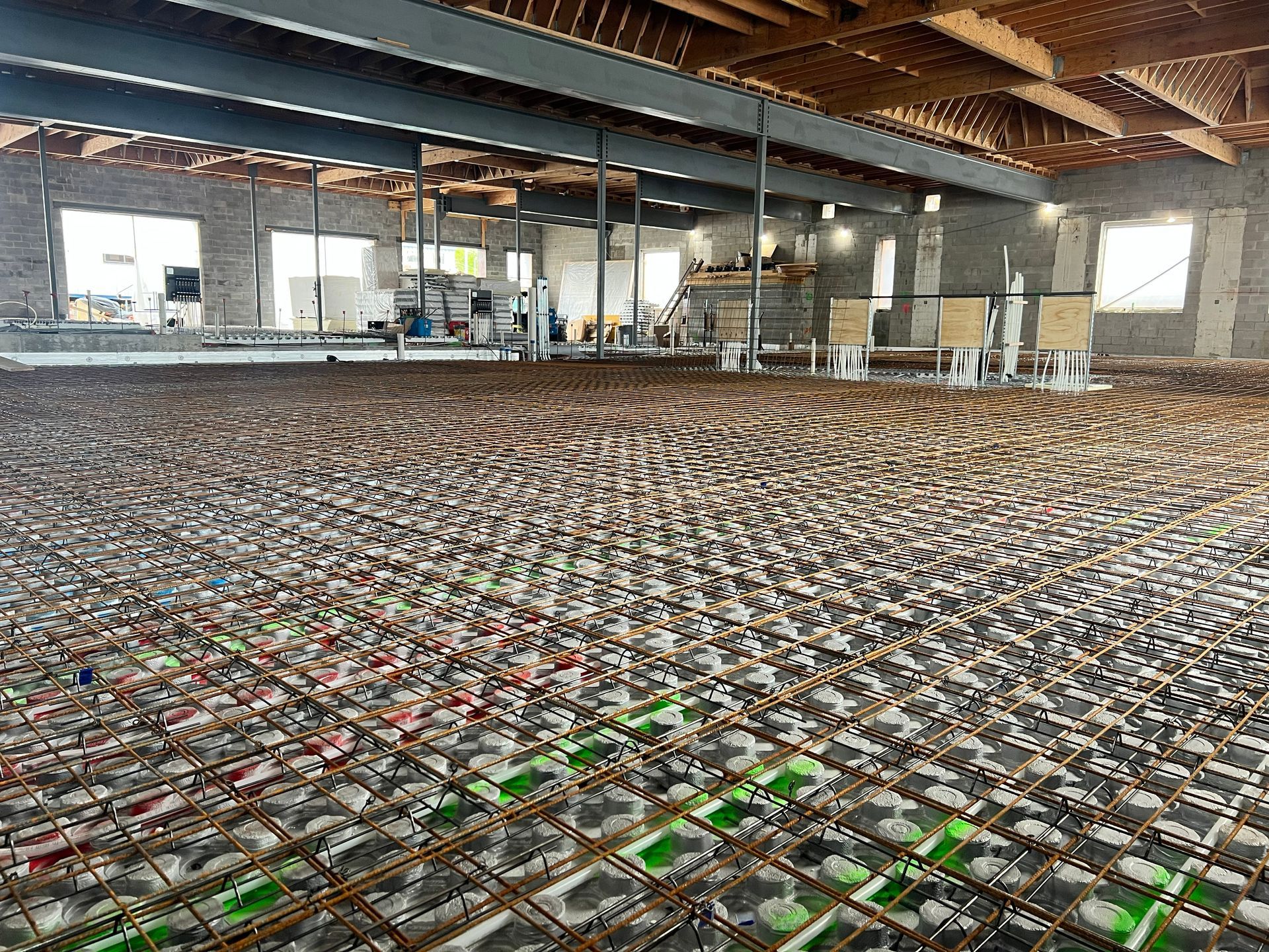 Rows of plastic crates filled with packaged goods inside a warehouse with exposed wooden beams