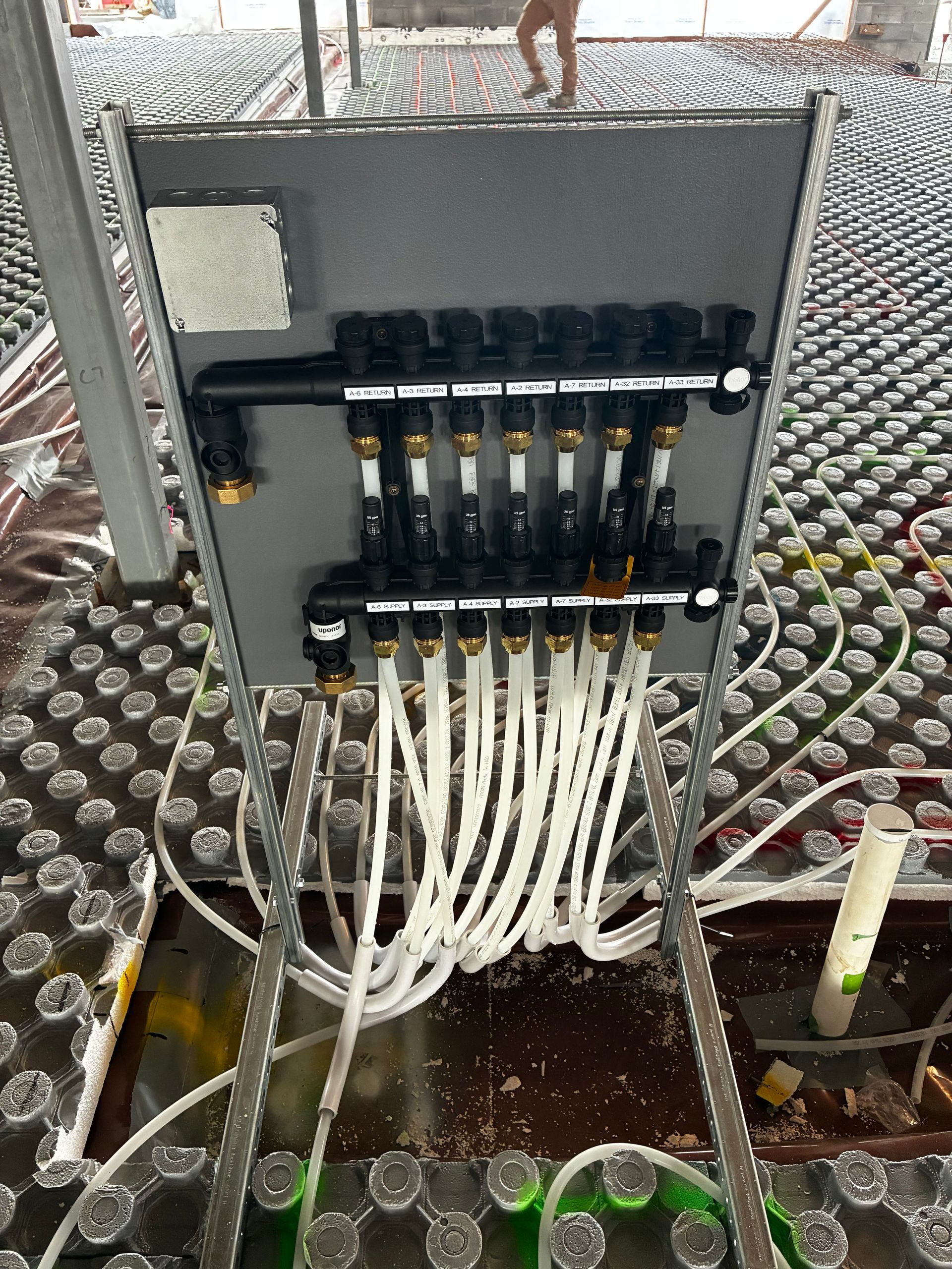 Fiber optic patch panel with multiple white cables connected in a rack-mounted enclosure