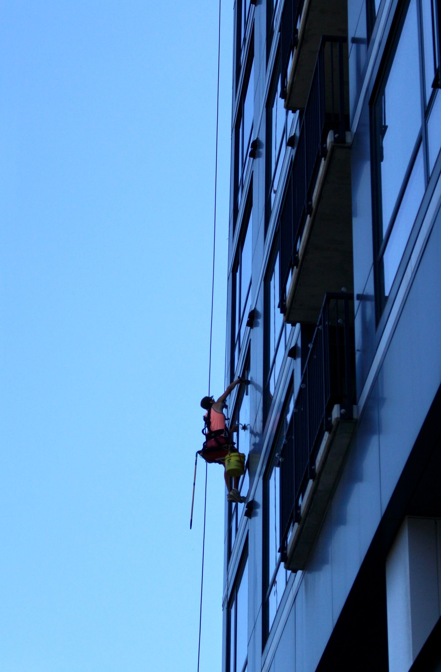 A man is climbing up the side of a building.