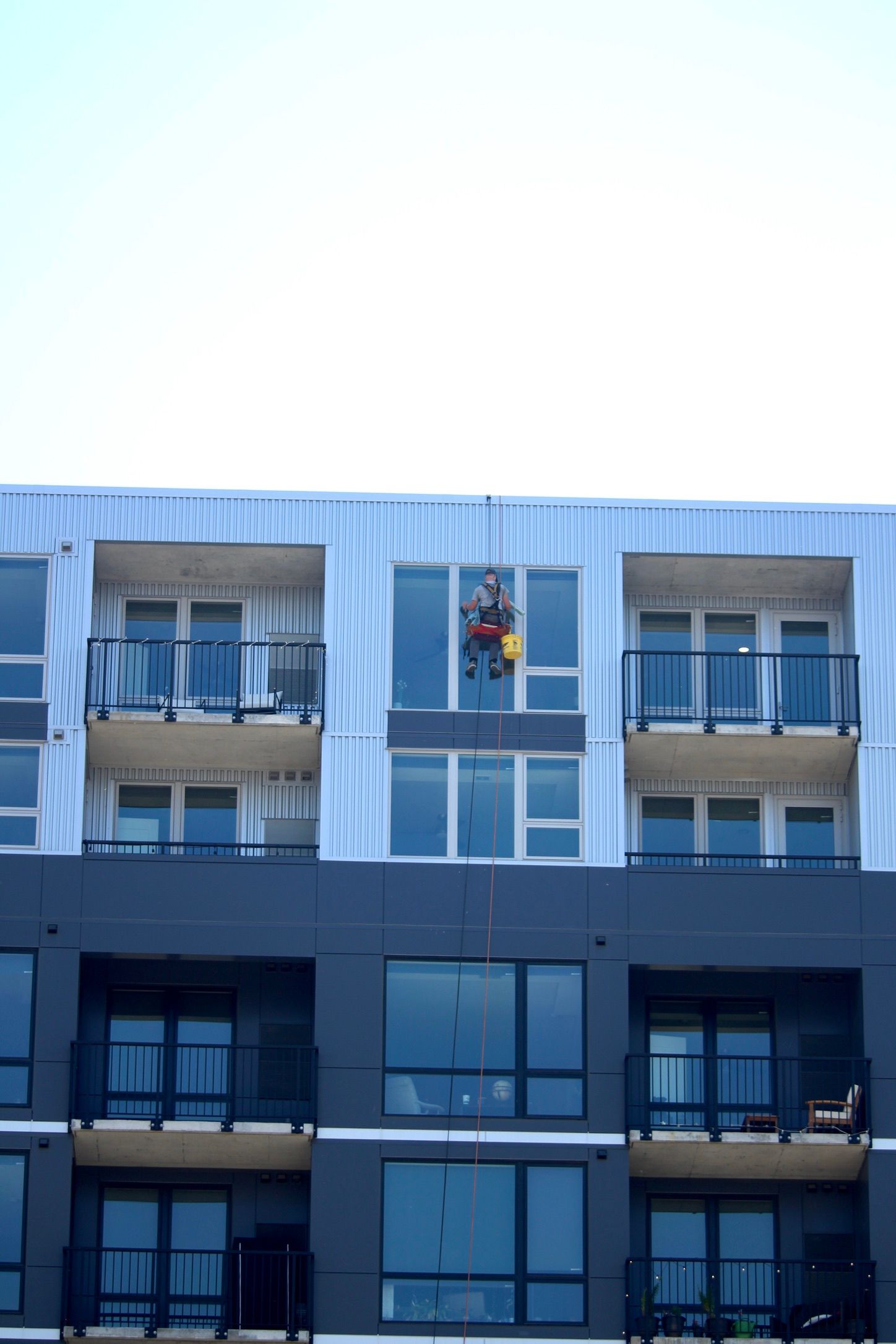 man cleaning the window in the building
